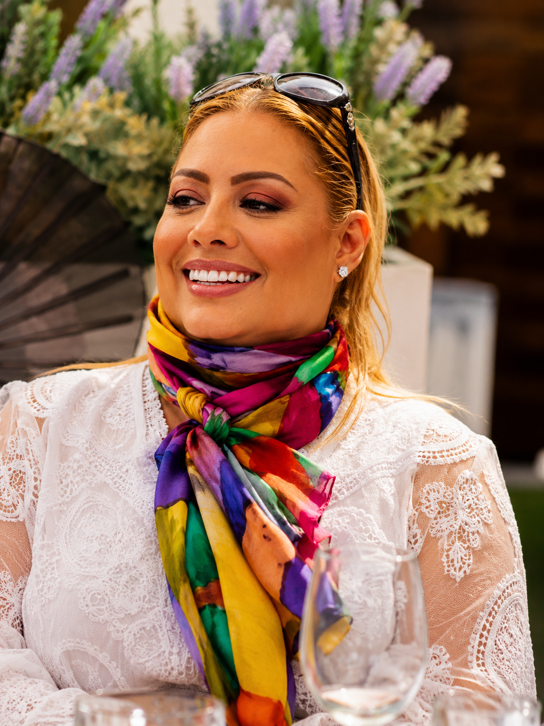 Yeidy Ramirez seated outdoors with colorful scarf